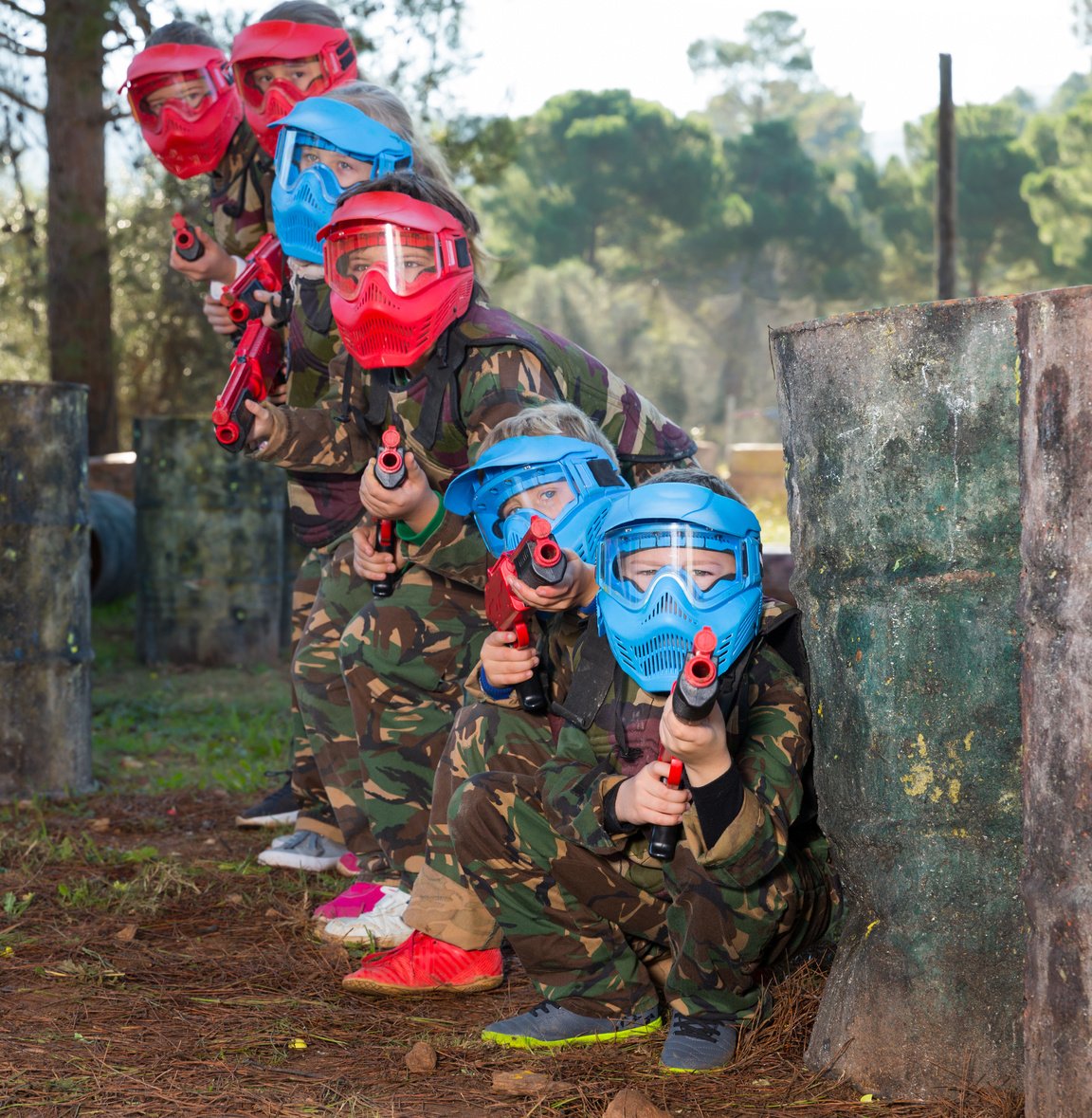 Group of lucky kids playing paintball